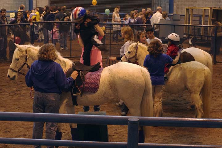 Child lifted to saddle